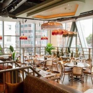 wooden tables and chairs and orange lampshades