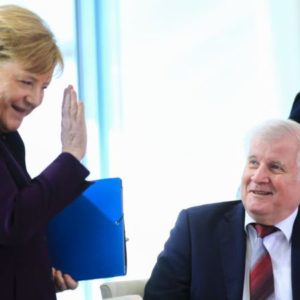 The German Chancellor went in for a handshake, then opted for a wave instead of a handshake