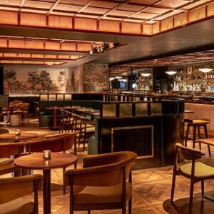 orange lighting around ceiling and brown chairs and tables on wooden floor